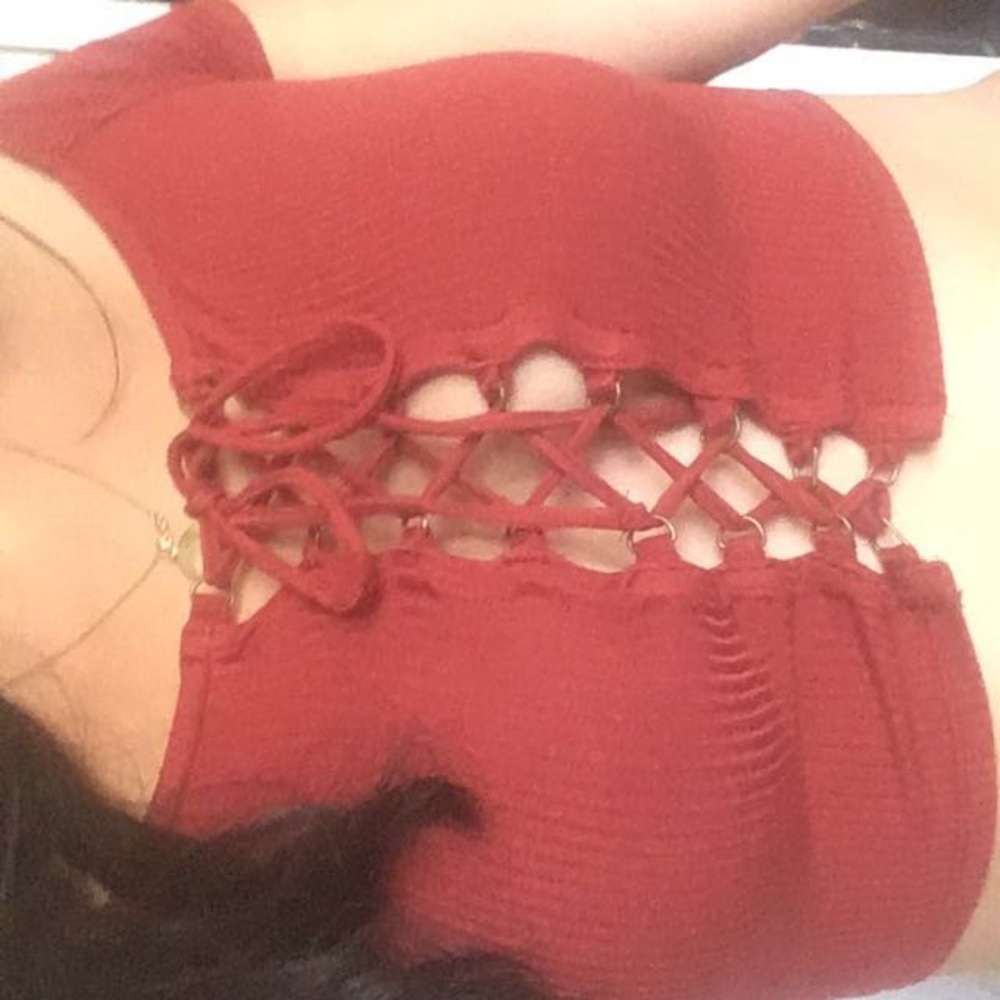 This is a brick red color crop top that laces up.