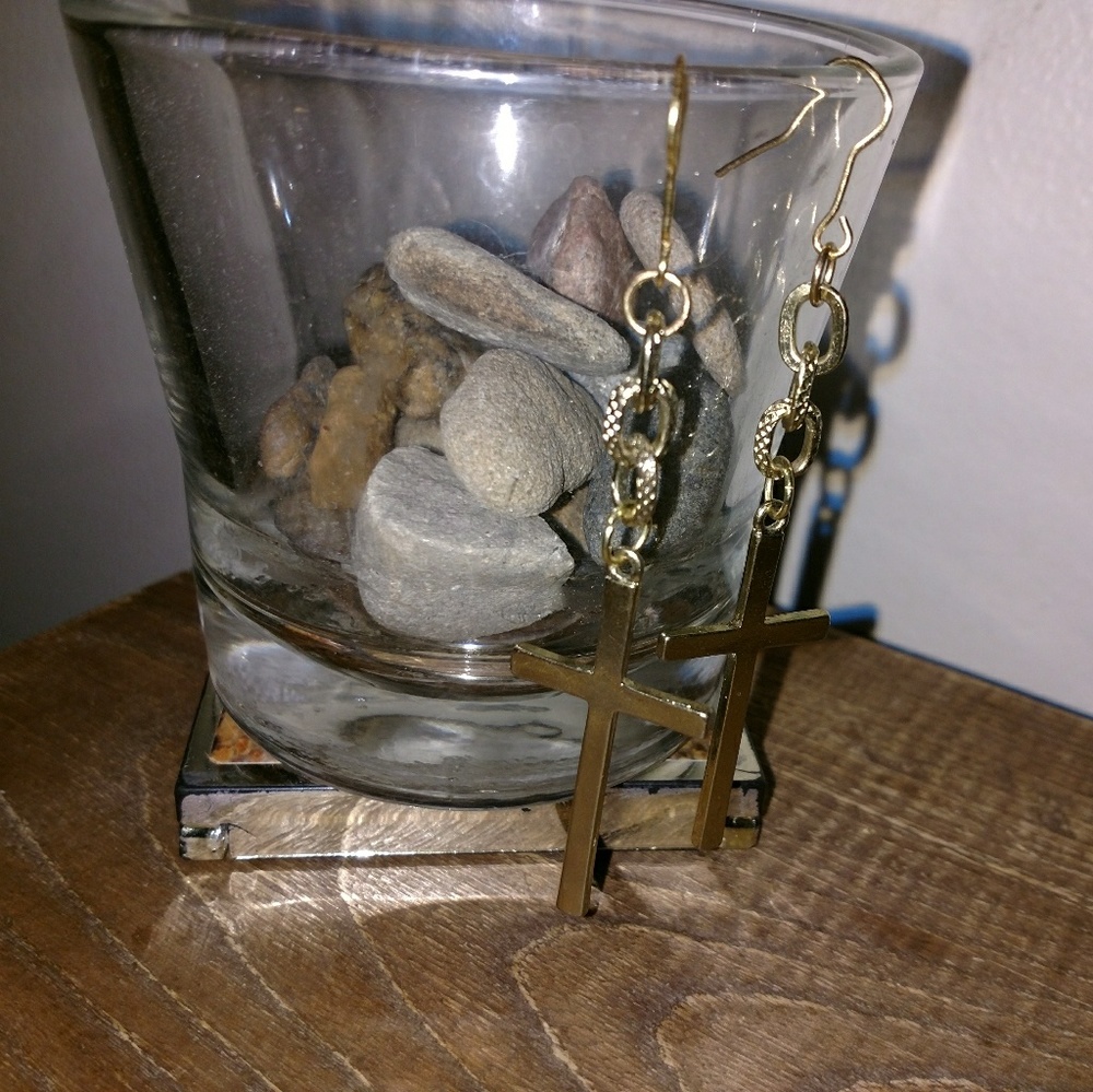 Gold cross earrings.