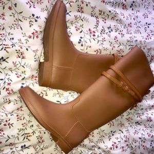 Knee high rain boots with faux leather detail.