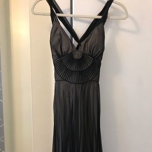 Black halter cross back dress with pleated skirt