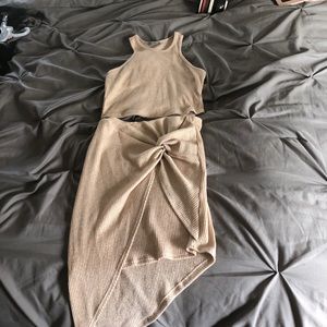 Gold crop top and asymetrial skirt ensemble.