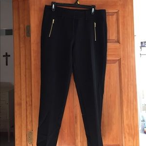 Black pants with gold zipper pockets