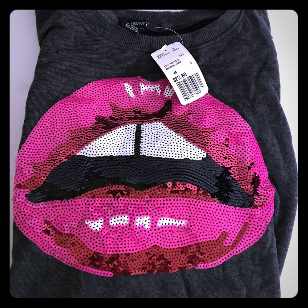 Grey and pink sequined sweater .