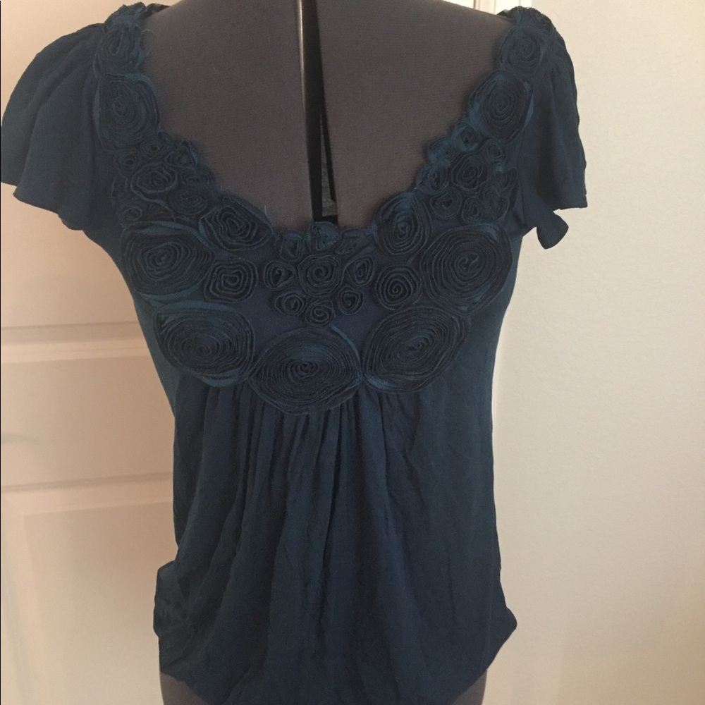 Green t shirt size small.   With details around