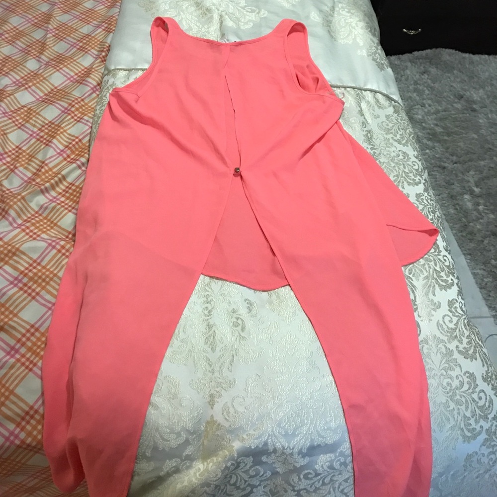 Sleeveless coral blouse.