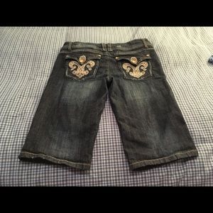 Jean capris (Bermuda shorts) with jeweled pockets.