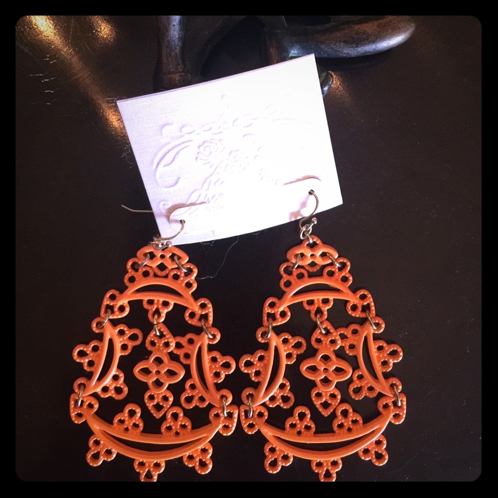 Orange hanging earrings.