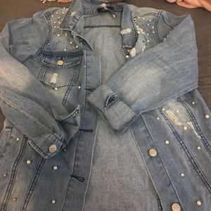 Jean jacket with pearl detailing on the front.