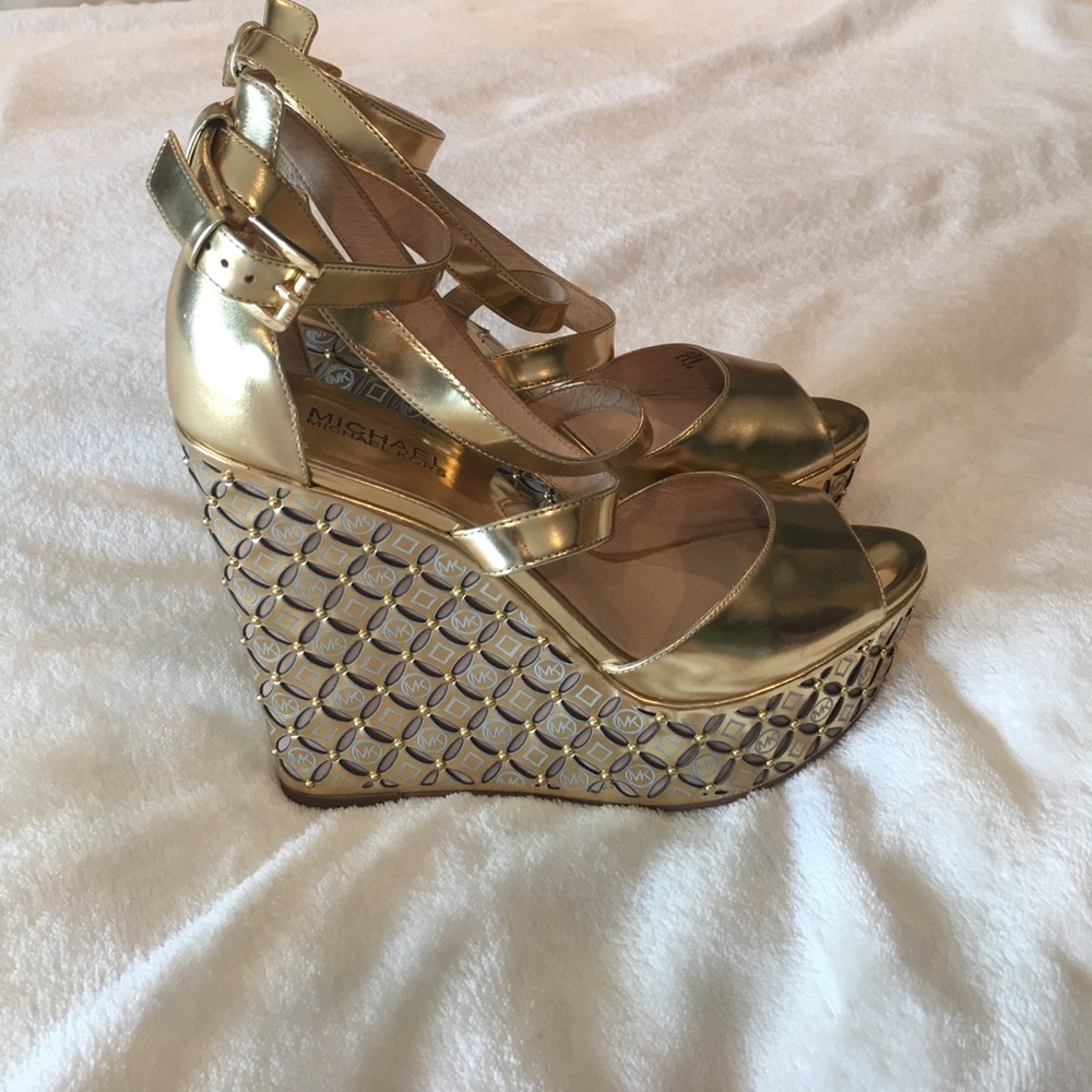 Gold Michael Kors high heeled wedges.
