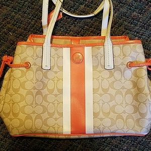 Used coach purse. Orange and tan. Authentic.