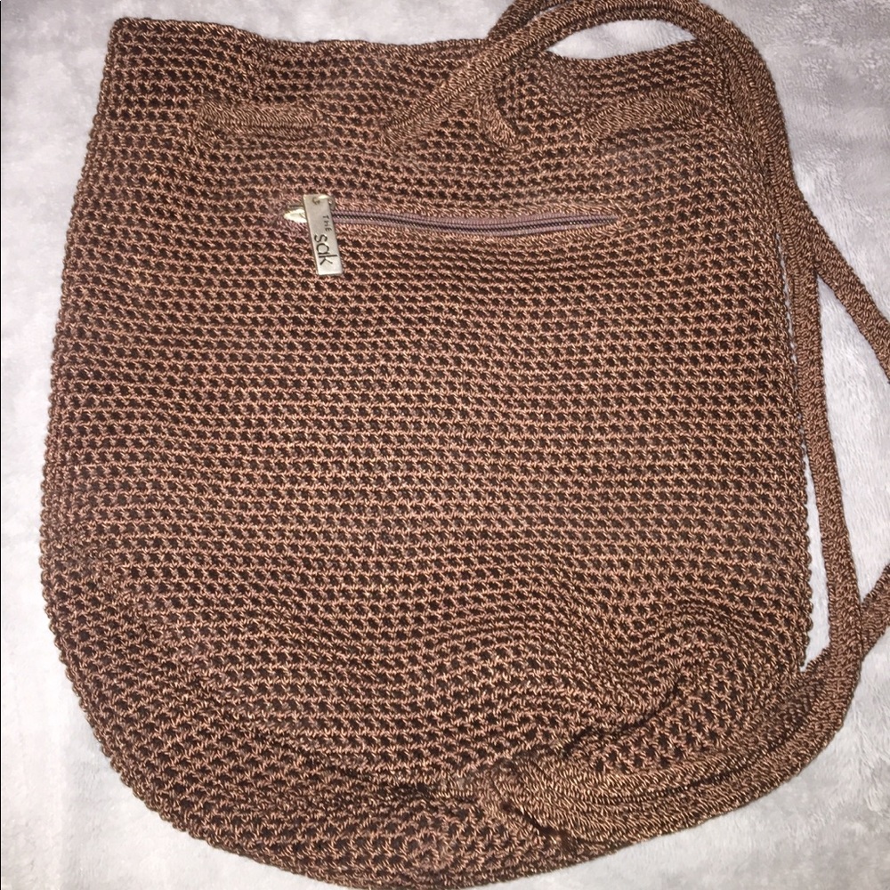 The Sak brown crochet sling backpack purse