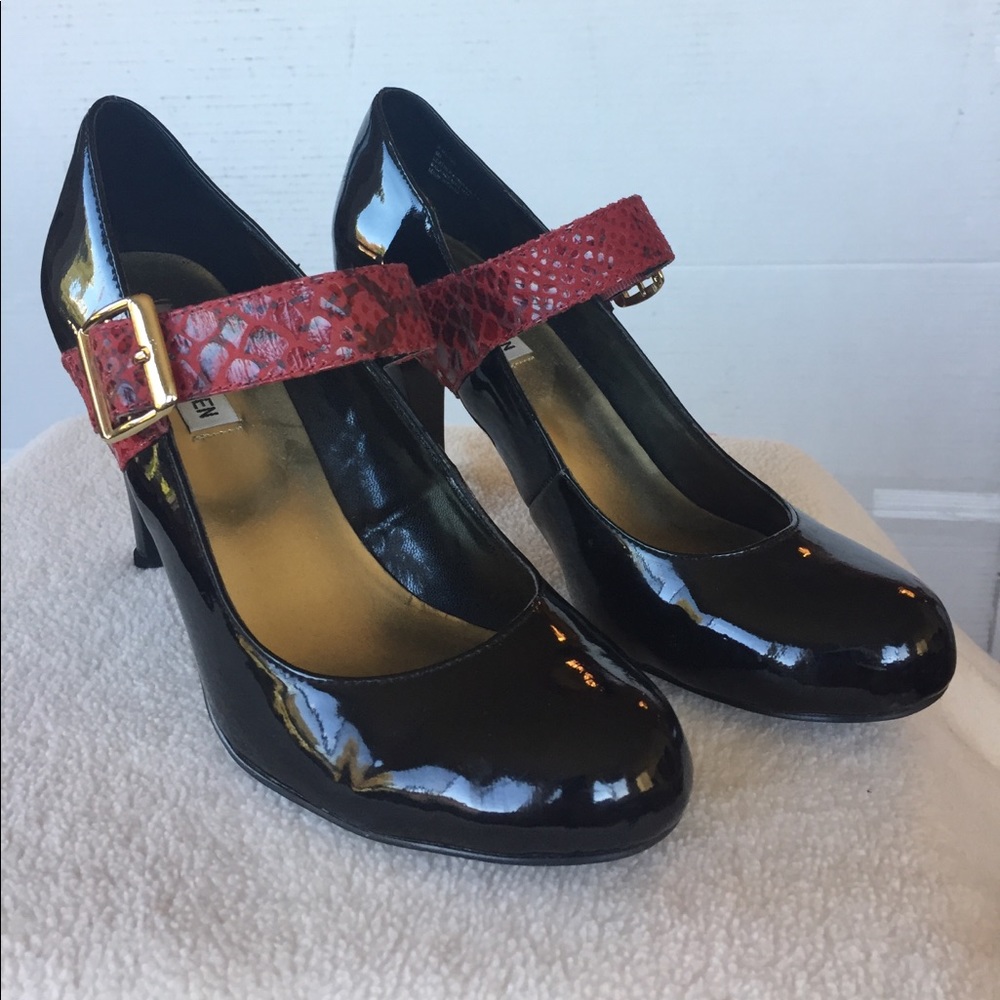 Black patent pumps with red strap and gold buckle
