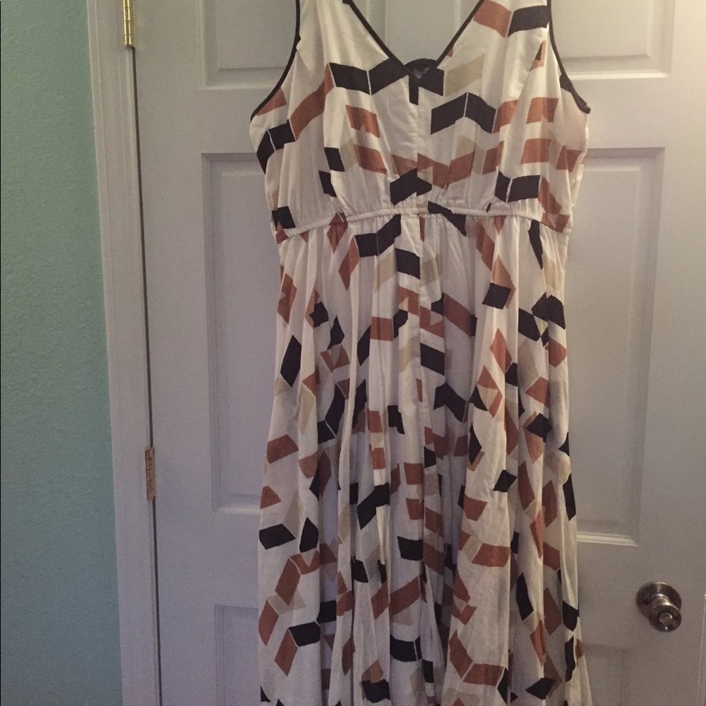 Sleeveless dress with a flowing ruffled skirt.