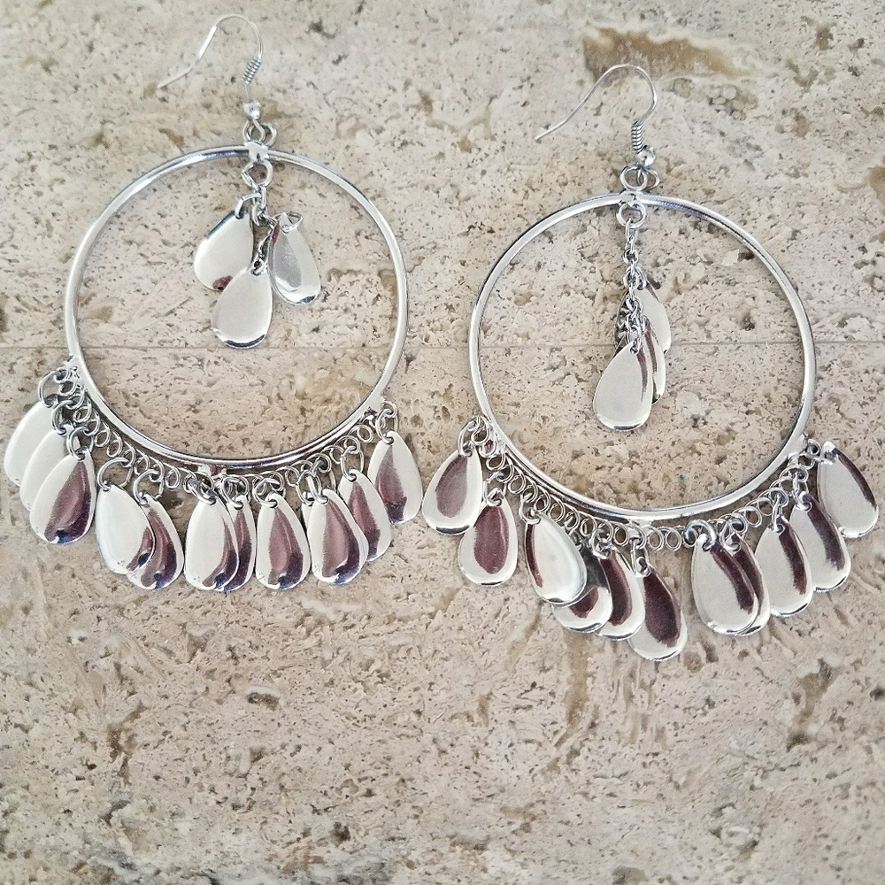 Silver hoop earrings with dangling teardrop detail
