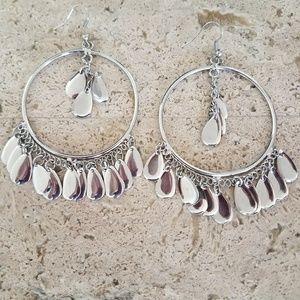 Silver hoop earrings with dangling teardrop detail