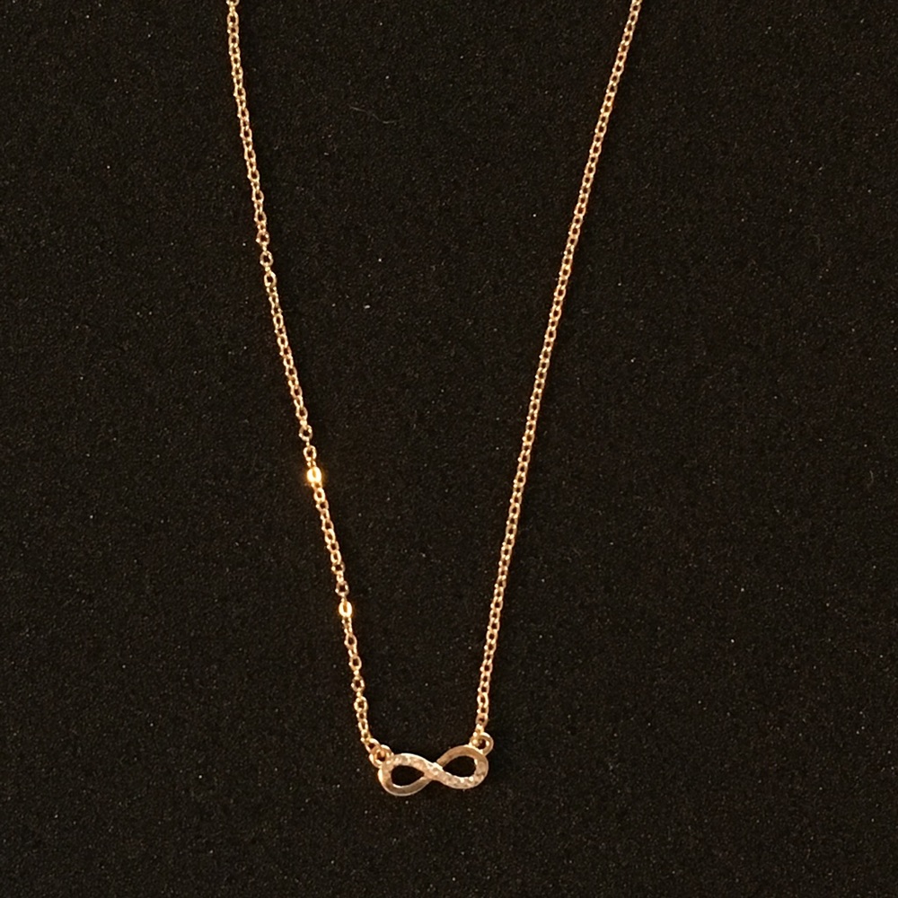 Infinity symbol gold necklace with gemstones