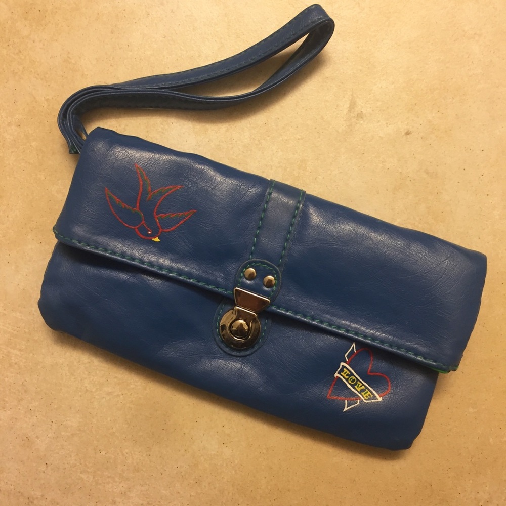Blue clutch with traditional tattoo style detail