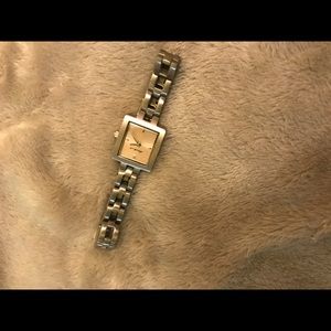 Eddie Bauer small silver watch with pink tint.