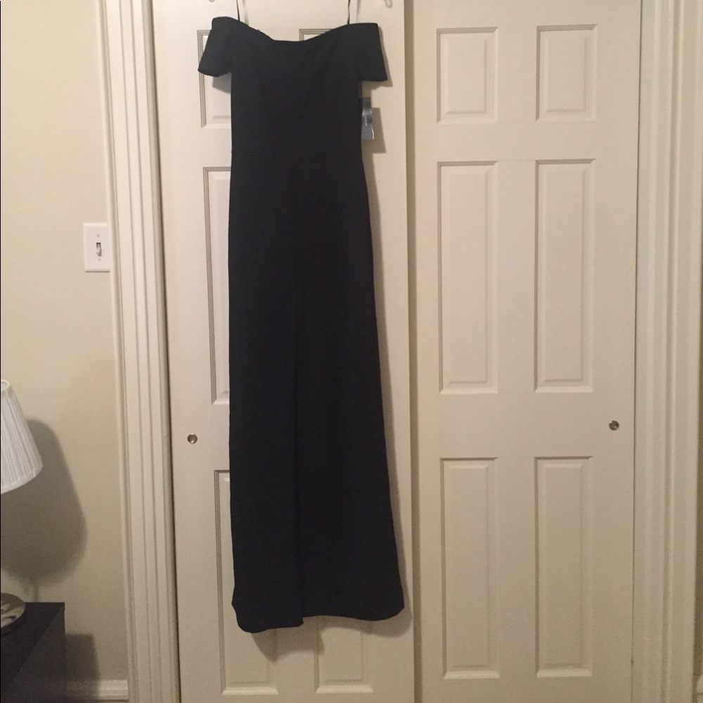 Off the shoulder all black jumpsuit.