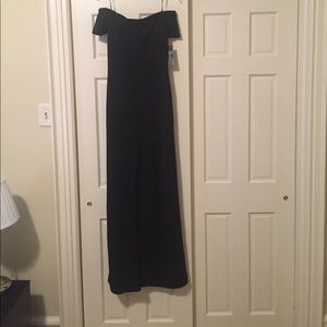 Off the shoulder all black jumpsuit.