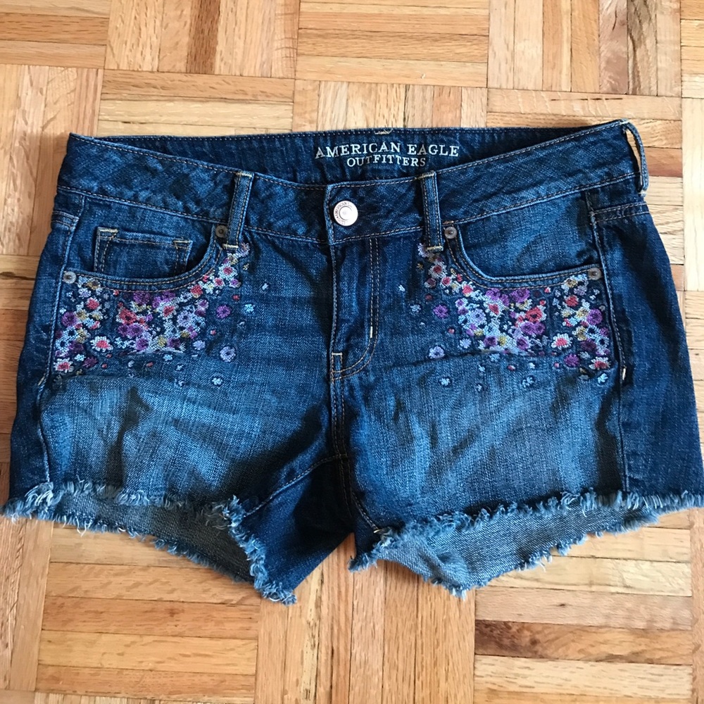 Dark jean cutoff shorts with floral embroidery