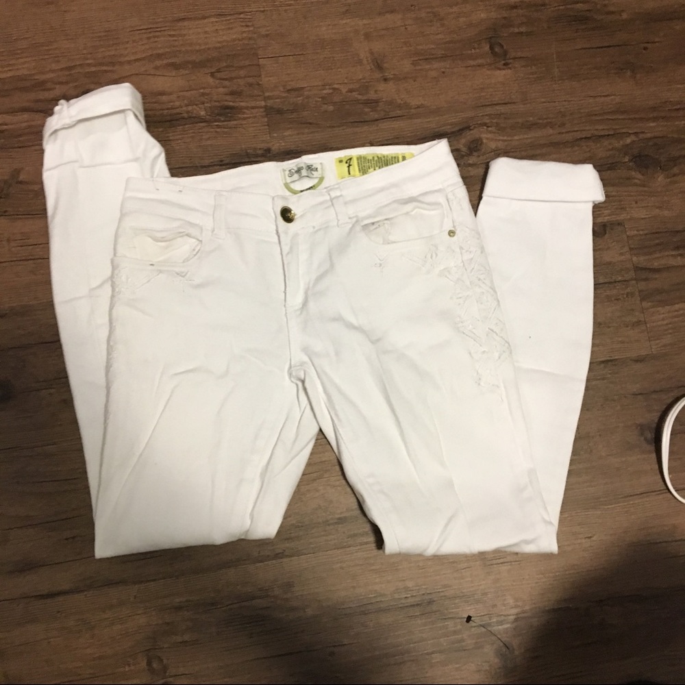 White pants with embroidered details