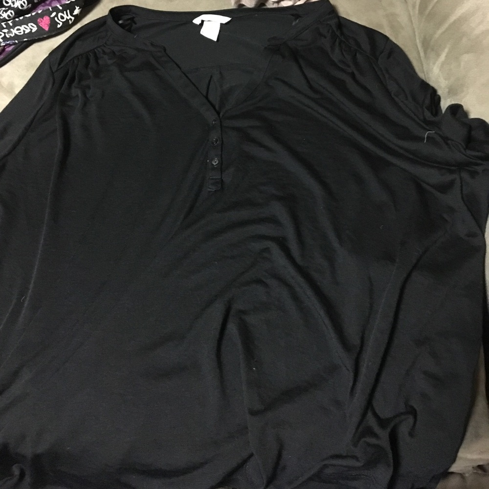 Black 3/4 length shirt. Buttons on the front