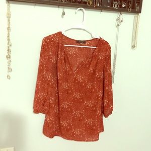 Orange/rust colored print blouse