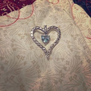Heart necklace charm with blue topaz gem inside