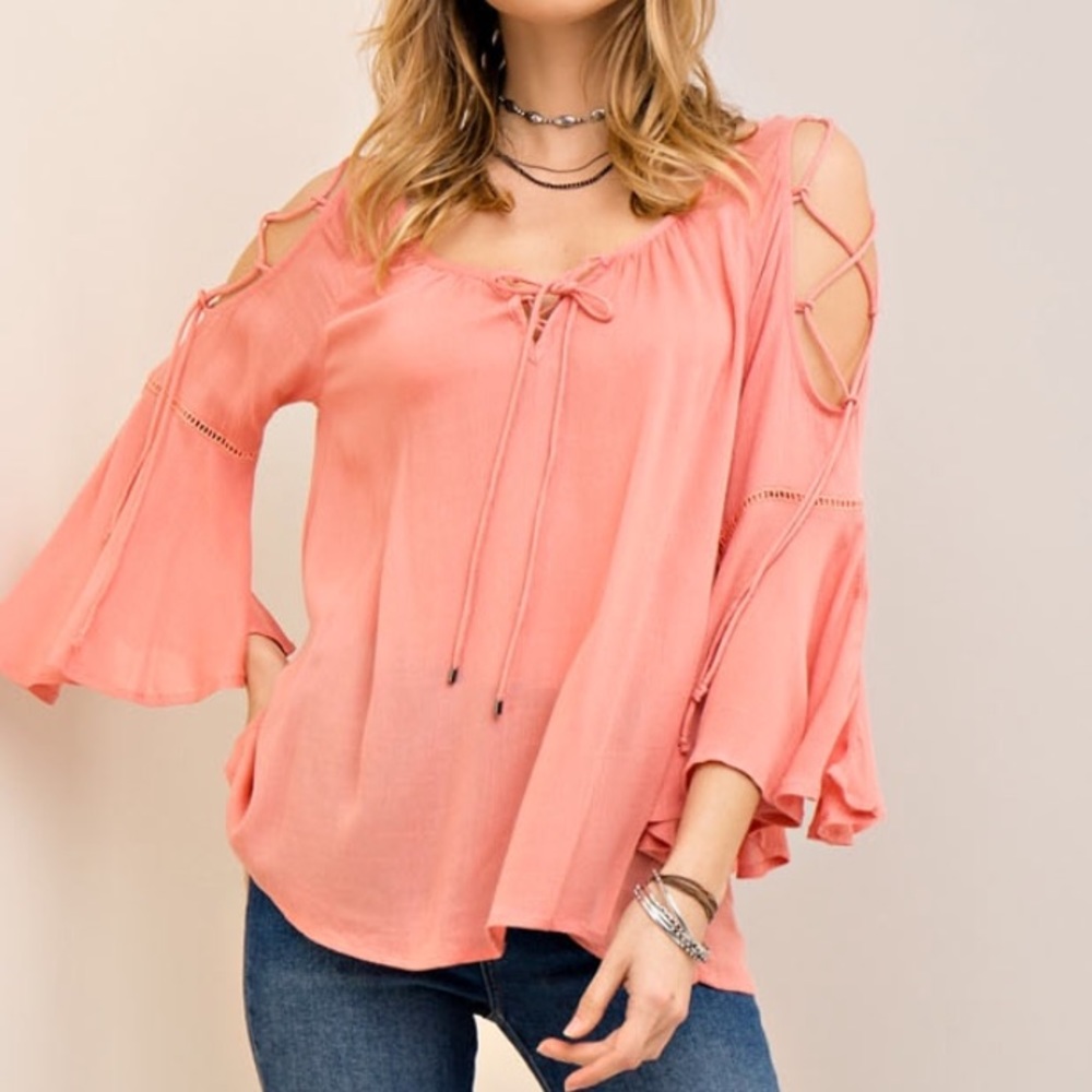 Coral colored top with lacing at chest/arms