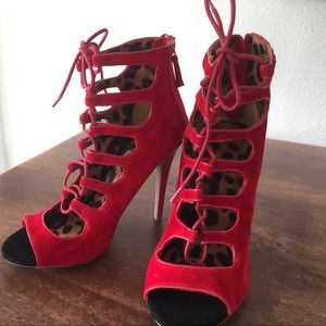 Red lace up high ankle heels. Never been worn