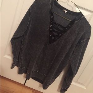Distressed V-neck lace up sweater