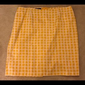 Yellow/gold and white, lined patterned skirt.