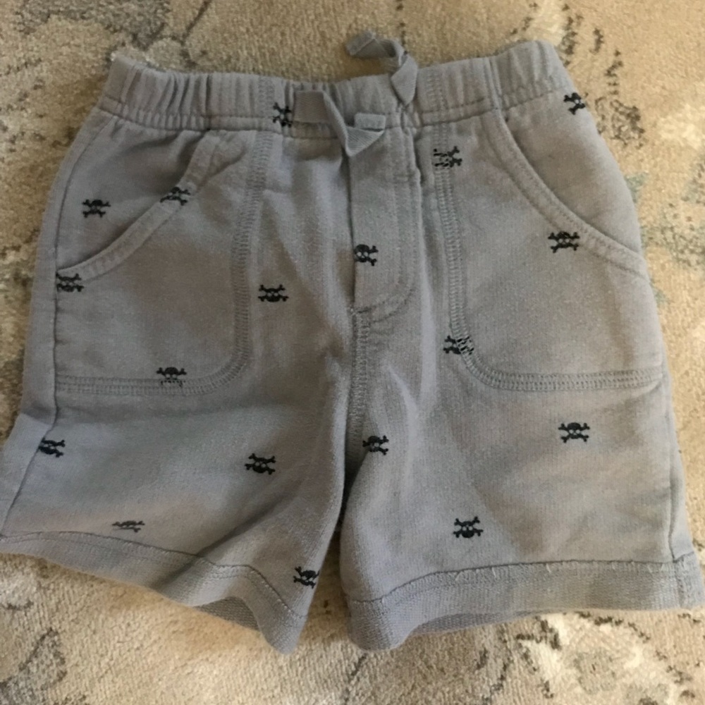 Gray baby shorts with black skulls