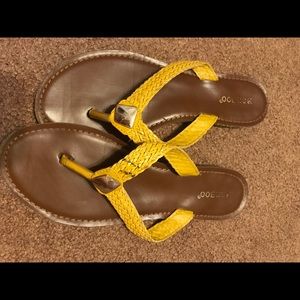 Yellow woven flip flops