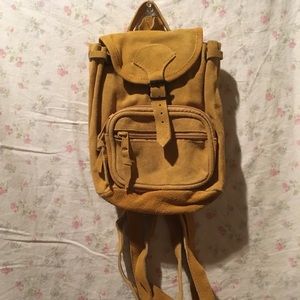 Mustard yellow suede backpack with zipper pocket