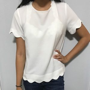 White top with scalloped edging