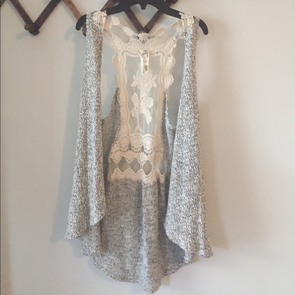 Sleeveless cardigan with shear lace back.