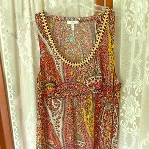 Sleeveless sheer top w button neckline. Red gold