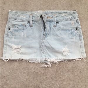 Distressed light blue denim mini skirt