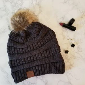 Pom pom beanie and stud earrings