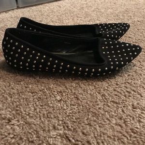 Black flats with gold accents.