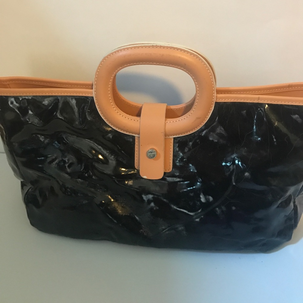 Black purse with hot pink lining and makeup bag.