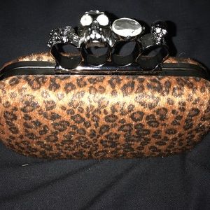 Leopard print knuckle skeleton clutch