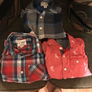 Three long sleeve boys button up shirts.