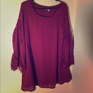 Red flowy dress with lace sleeves.