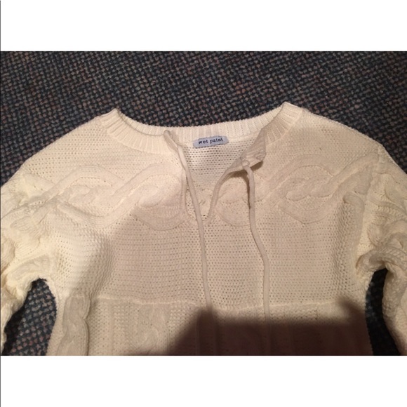 Small cableknit sweater with tie strings at neck. - Picture 2 of 3