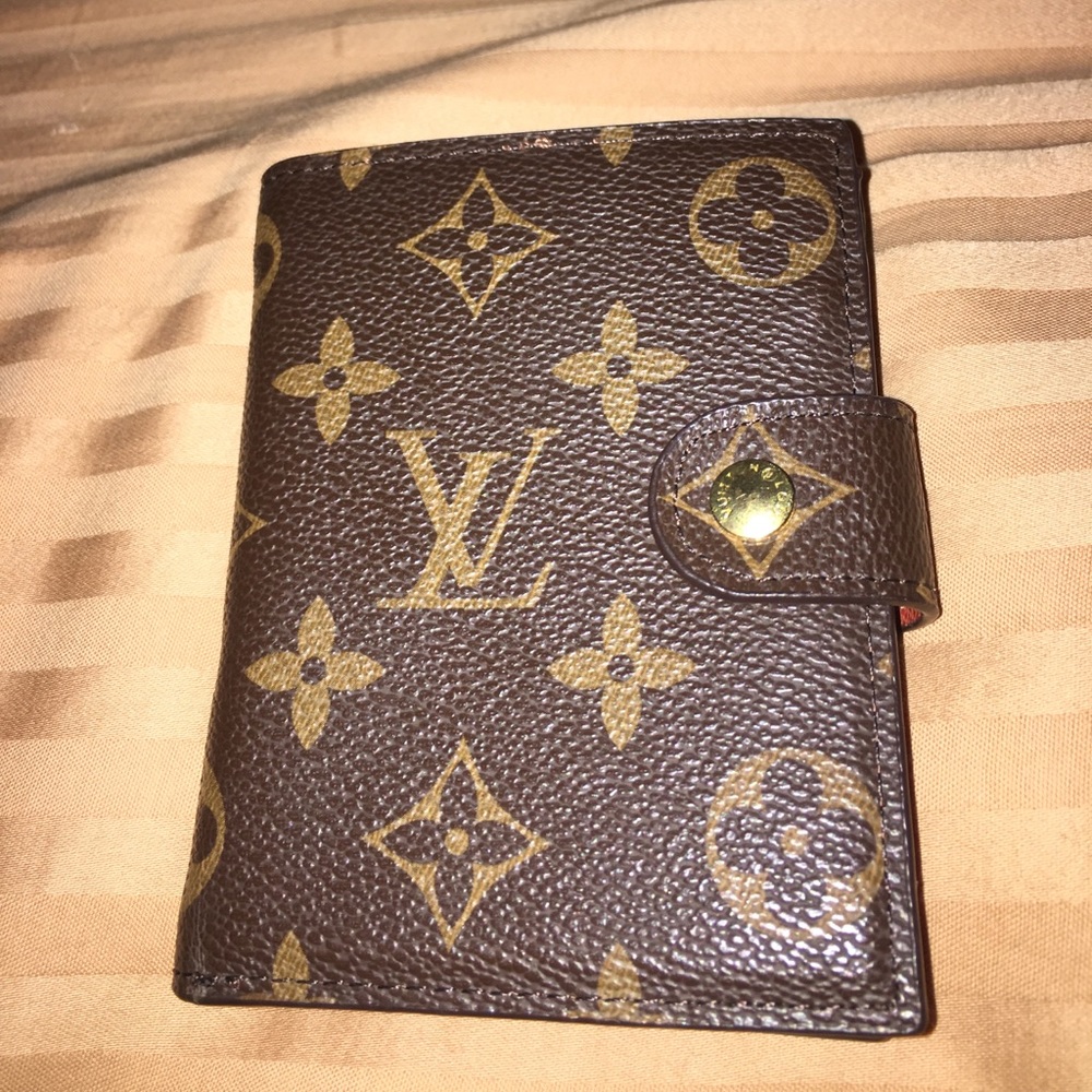 Louis Vuitton brown leather bifold wallet.