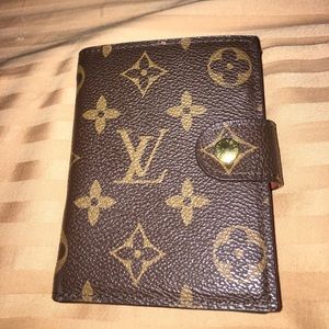 Louis Vuitton brown leather bifold wallet.