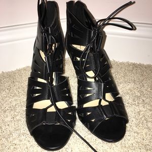 Black lace up heeled shoes
